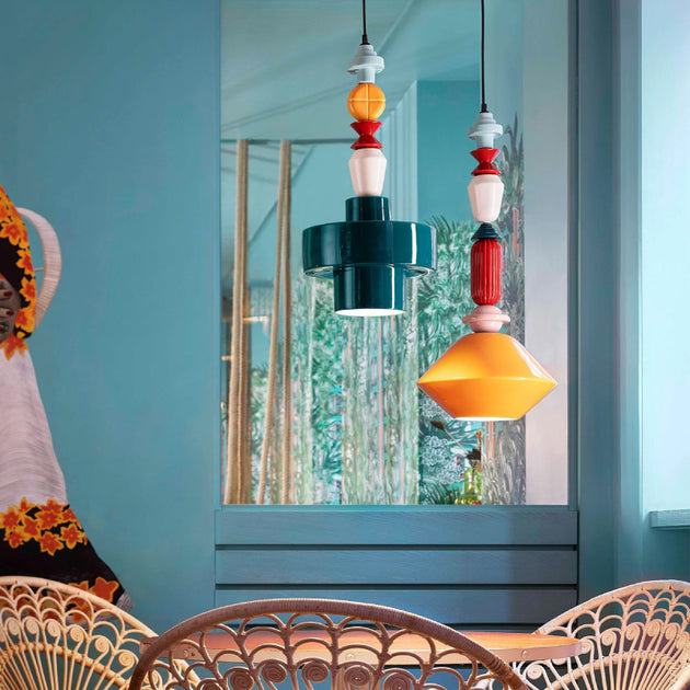 Playful and Colourful Ceramic Cylinder Pendant with diamond pendant over a table in a colourful Mexican style living room