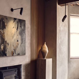 Minimalist Rotatable Angled Wall Light | Lighting Collective | small bronze in a contemporary living room
