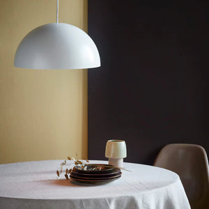 scandinavian matt metal dome pendant with white finish over a dining table