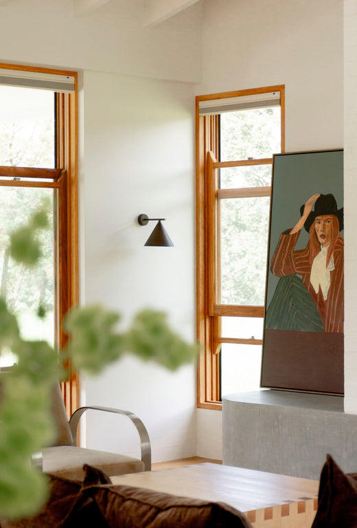 Straight Arm Iron Cone Wall Light next to Hattie Zampa's paiting at Loehill House