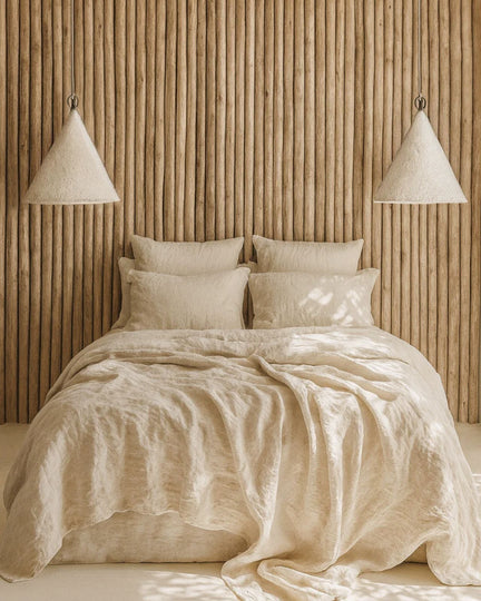 Luxury coastal home with organic bedside wall lights in a neutral cream colour