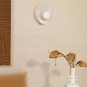 Dual Alabaster Disc Wall Light in a beige lounge near a sofa