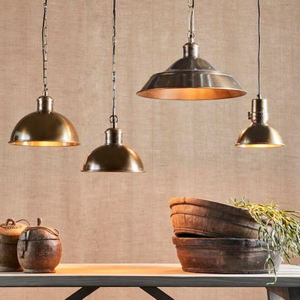 Antique Brass Industrial Dome Pendant hung with other pendants over a dining rustic table