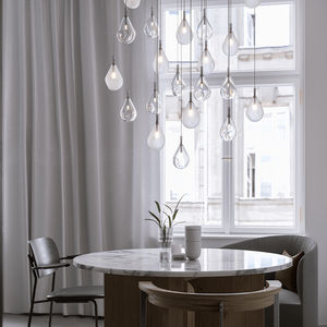 Hand-Blown Droplet Pendant Light clear and froster composition over a dining table 