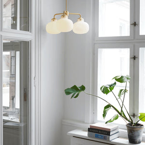 Three Light Mid-Century Modern Pendant in a living room by the window