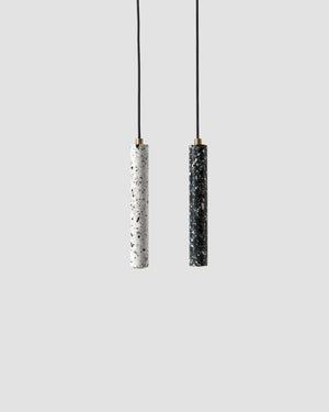 Two pendant lights with black and white cylindrical shades on a light gray background