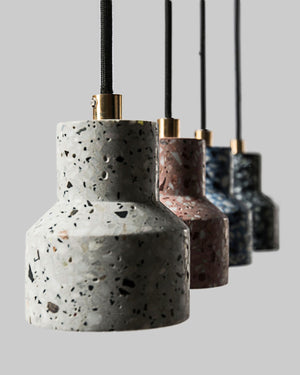 Terrazzo pendant lights with gold accents on a gray background