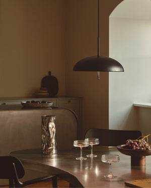 Small Curved Dome Black Shade in Warm Interior with cocktail glasses and grapes on table - Lighting Collective 