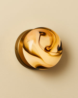 Glass Marble wall light on a beige background