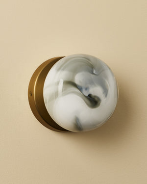 Decorative wall sconce with marble-like design on a beige background