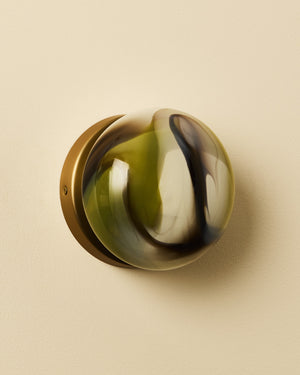 Round white light brass rim and multicolored center on a beige background