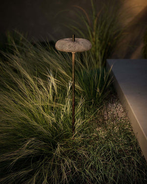 Concrete & Brass Garden Lamp round shade in a garden at night time