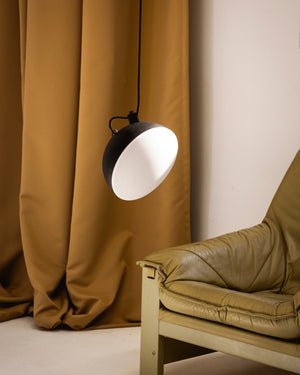 Contemporary pendant next to green couch 