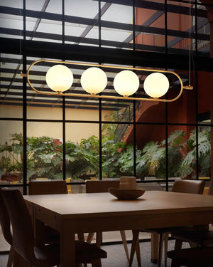 Modern dining room with a long rectangular table and chairs, featuring a Contemporary Opal Orb Linear Pendant