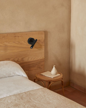 Bedroom with wooden headboard, round nightstand and Contemporary Steel Wall Light