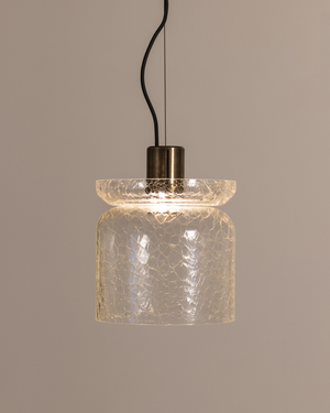 Pendant light with crackle glass shade on a neutral background