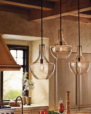curved blown glass pendant light in a mediterranean kitchen