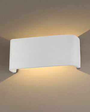 White wall-mounted light fixture on a gray wall