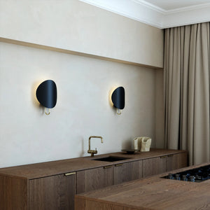 Modern Curved Disc Wall Light black in a kitchen