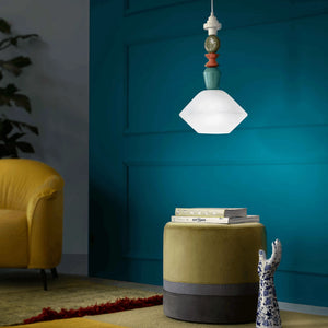 Playful and Colourful Ceramic Diamond Pendant milk white finish over a soft green table