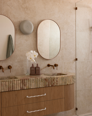Bathroom vanity with a ceramic Eclipse wall sconce from Studio Enti