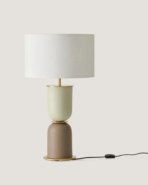 Two-toned table lamp with a white shade on a light gray background