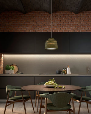Modern kitchen with round dining table and chairs, Silicone pendant light, and brick wall.