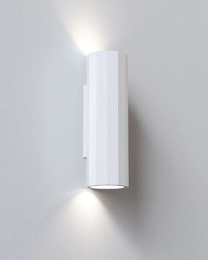 White wall-mounted light fixture on a gray wall