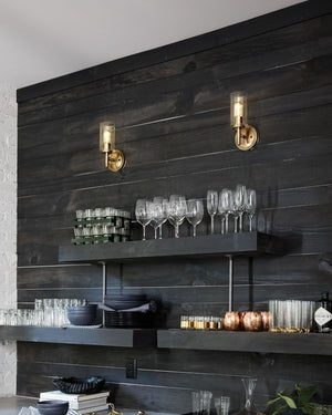 two glass vintage lights installed above a kitchen with black shelves and walls