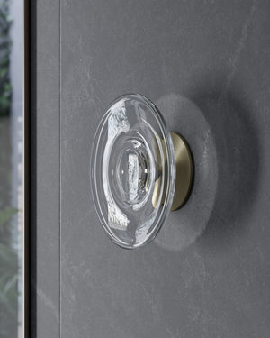 Clear glass wall light on a dark grey door