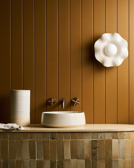 Bathroom sink with faucet against a wooden wall