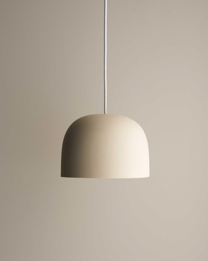Beige dome pendant light against a plain light brown background