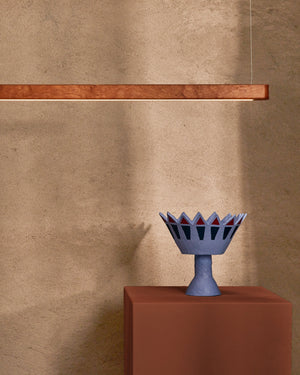 Handmade Timber Linear Pendant House hanging with a pink and beige background