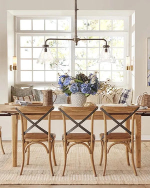 Industrial Two-Arm Pendant Over a dining table in a farmhouse style dining room