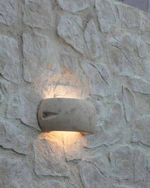 Italian Terracotta Outdoor Up/Down Wall Light installed on a stone wall | Lighting Collective
