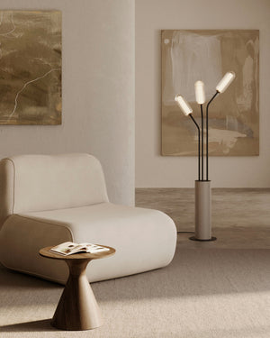 Modern living room with a beige armchair, side table, and floor lamp.