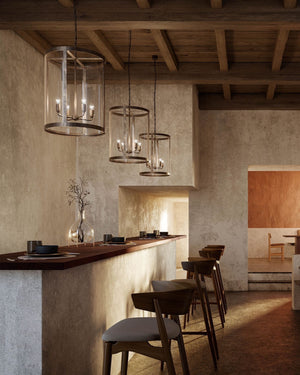 Three large lantern pendant hanging over a high table in a restaurant