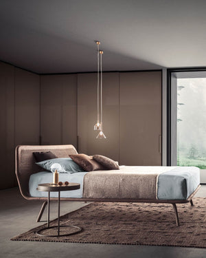 molecola table lamp on a bedside table in a neutral modern bedroom