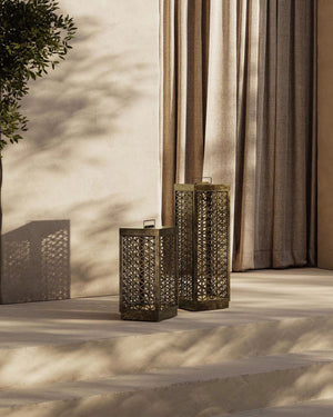 Small and large Mediterranean perforated floor lamps in a patio near stairs
