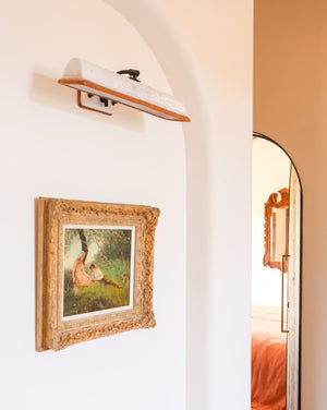 Brass Arm Ceramic Wall Light Above a picture frame | Lighting Collective | Lo Scoglio Project