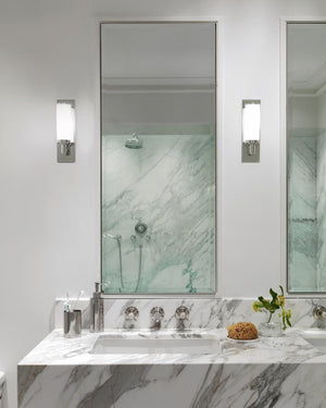 Two Transitional Cylindrical Chrome & Glass Wall Light insalled above a dual vanity