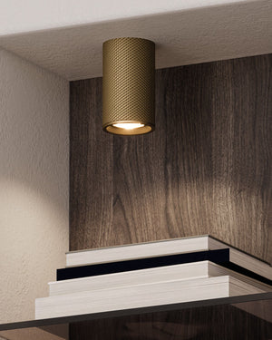 Modern ceiling light fixture on a wall with a wooden panel