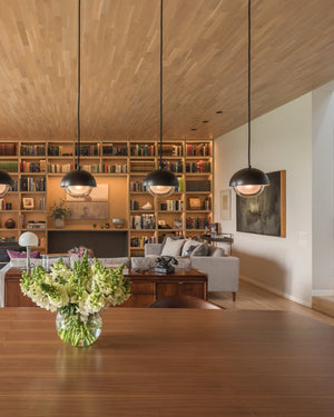 Modern living room with bookshelves, featuring  four round shape pendants