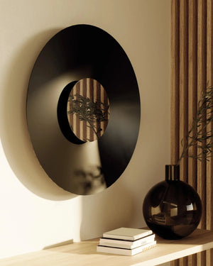 Minimalist Mirrored Disc Wall Light above a shelf with books and a vase.