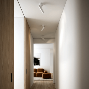 Minimalist Tiltable Spotlight | Lighting Collective | white in a hallway