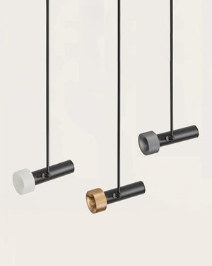 Modern pendant lights with black and gold fixtures on a white background