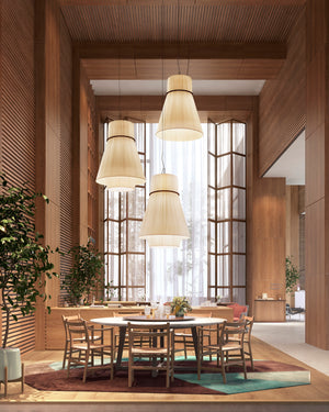 Modern dining area with wooden furniture and pendant lights in a well-lit room.