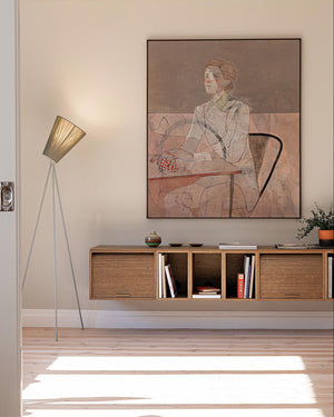 Modern Contemporary Tripod Floor Lamp with wooden cabinet, floor lamp, and wall art.