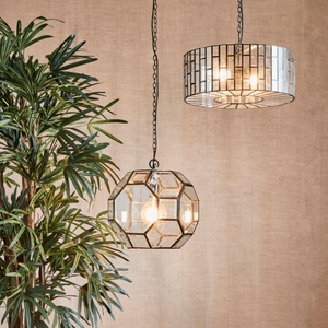 Modern Mid-Century Black Drum Chandelier | Lighting Collective | pendant together with a geometric chandelier in a beige interior