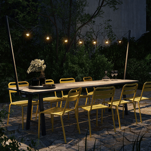 Modern Portable Festoon Lights | Lighting Collective | on a terrace over a dining table 